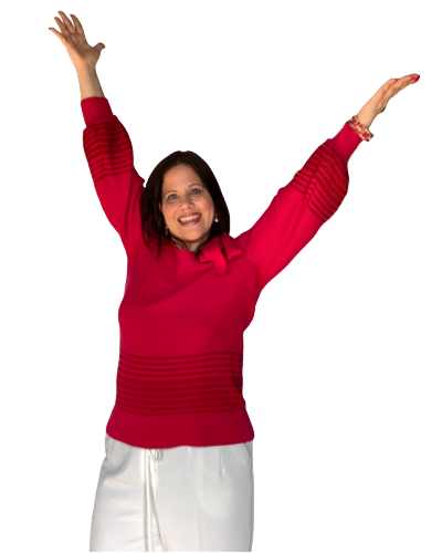Deirdre jumping with arms in air pink sweater